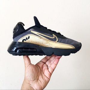 black nike shoes with gold swoosh